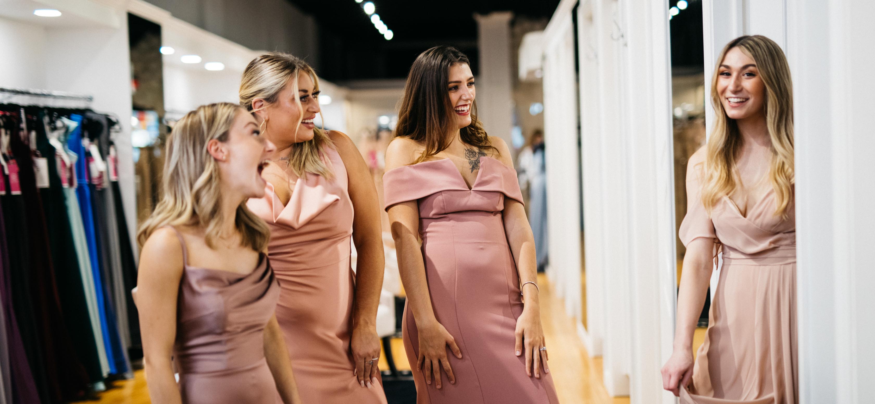 Bridesmaids trying on dresses.