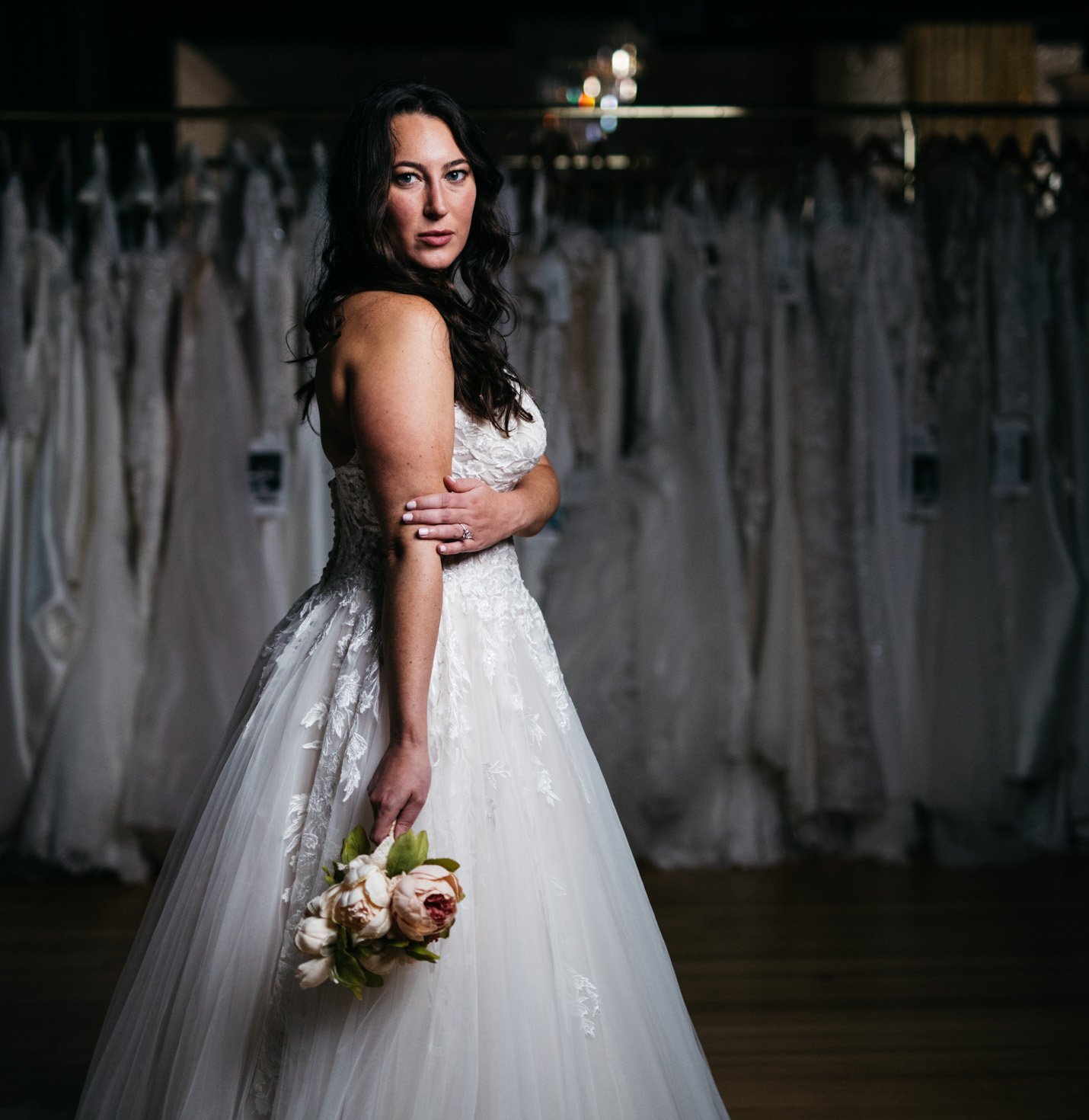 A bride with a dress and her flowers.