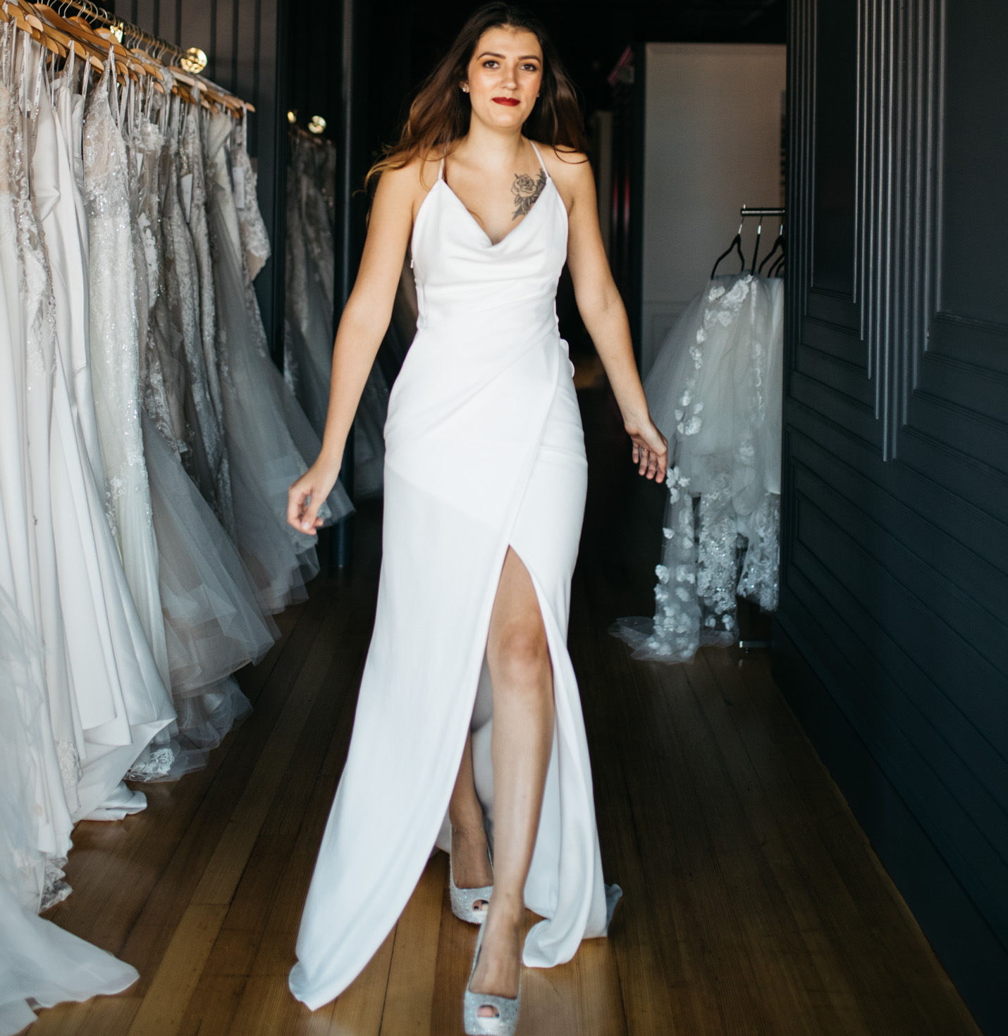 A bride trying on shoes and a dress.