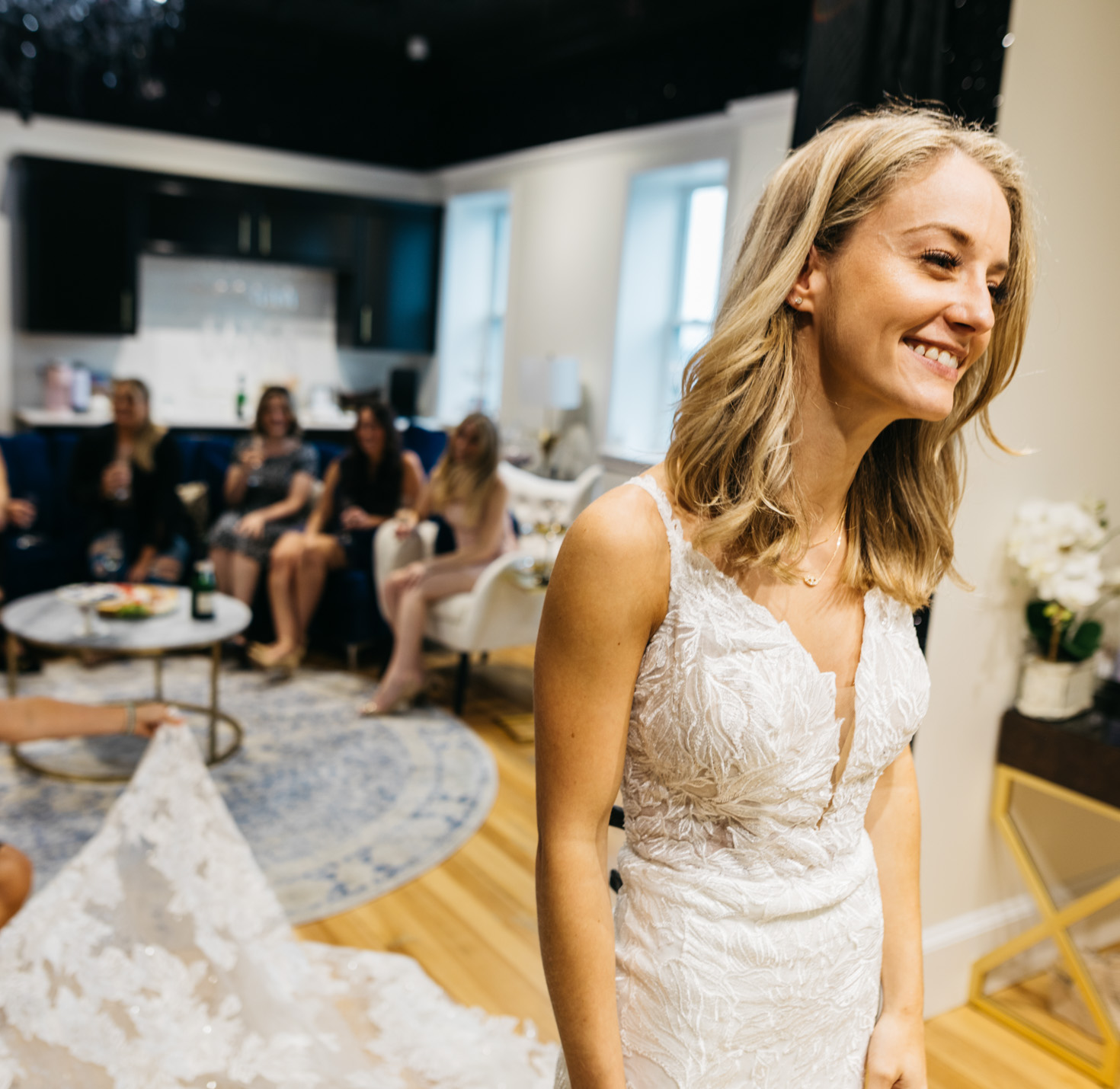 A bride smiling in a wedding dress.