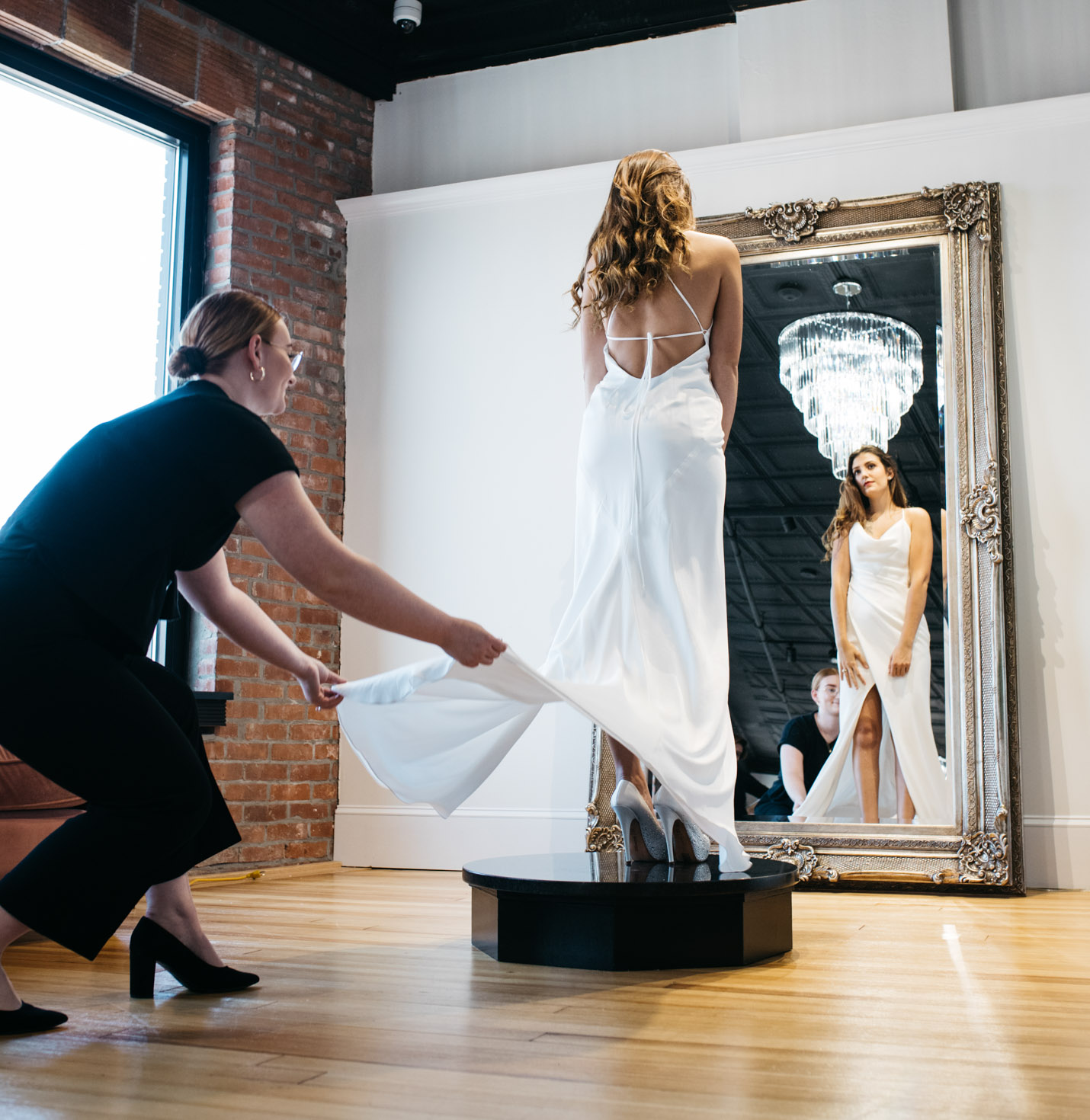 A bride trying on a dress.