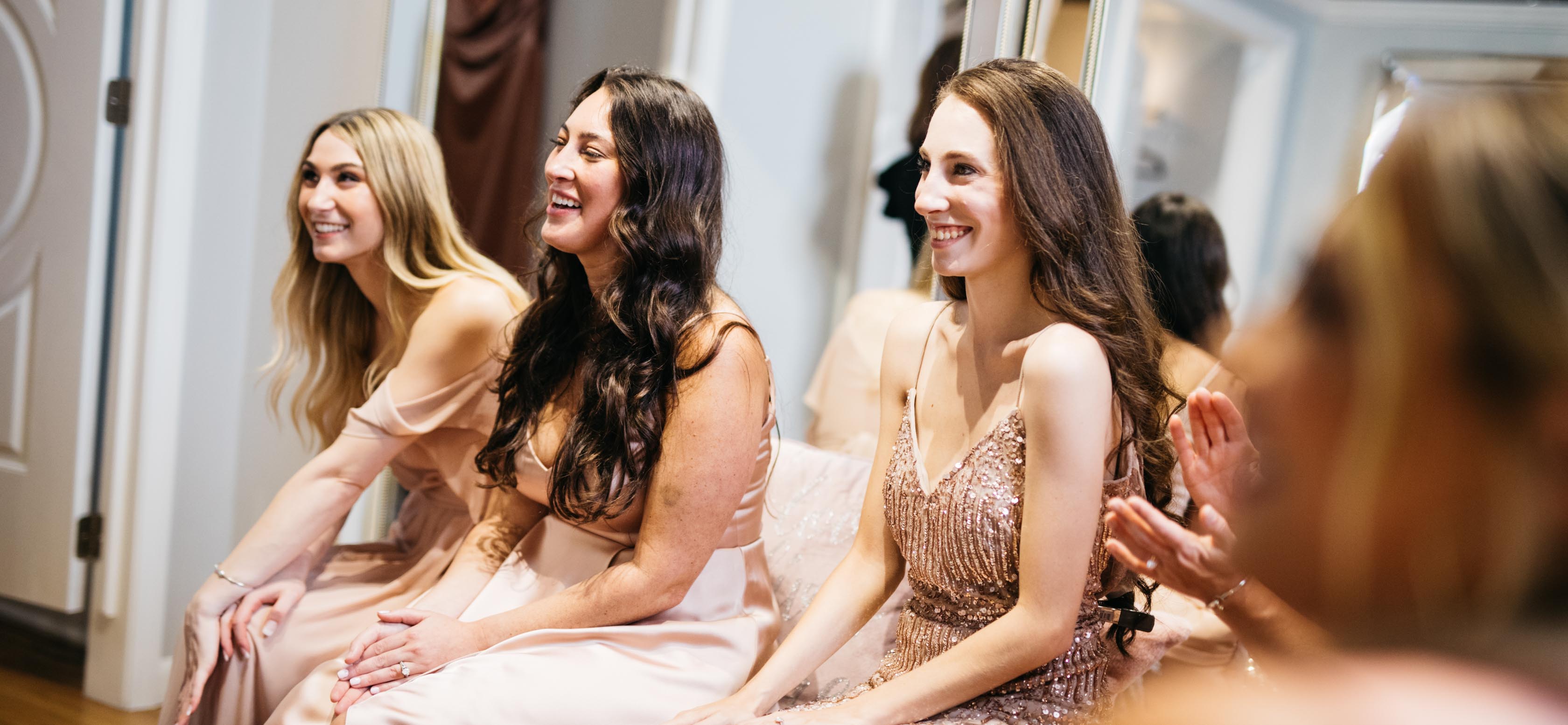 Bridesmaids trying on dresses in the store.