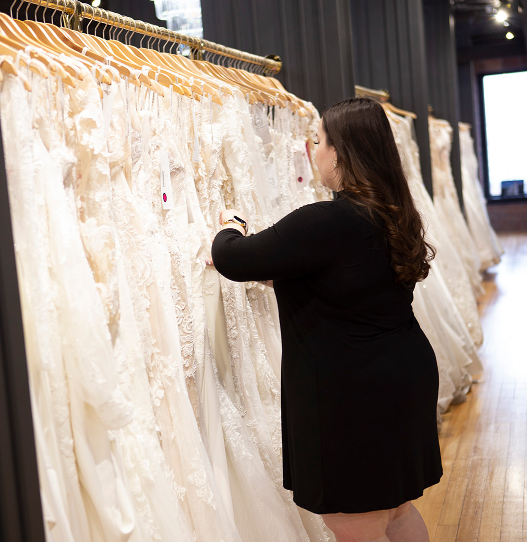 A stylist working to find dresses for a client.